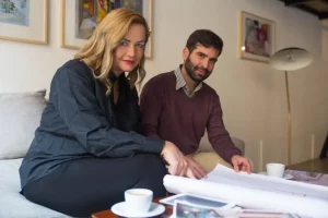 Real estate agent presenting floor plan