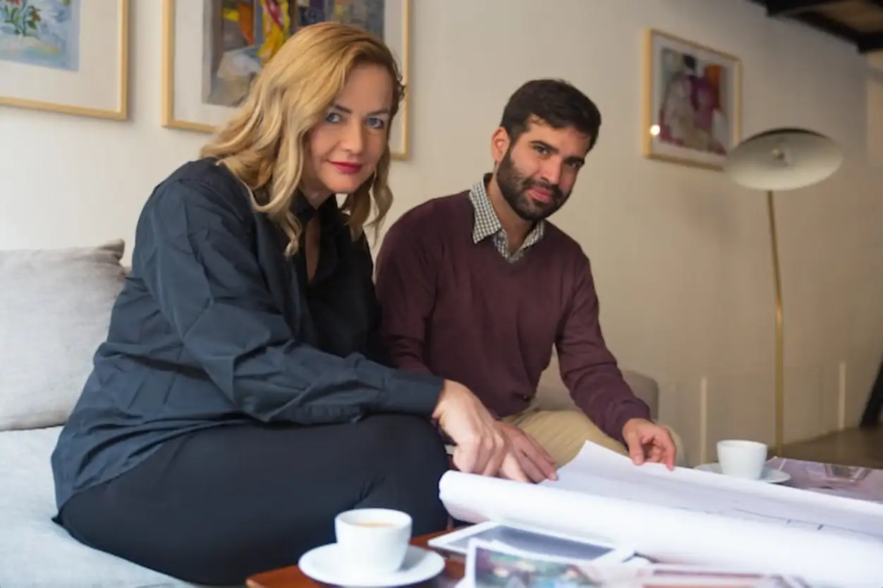 Real estate agent presenting floor plan