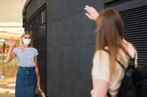 Friends saluting each other at the mall