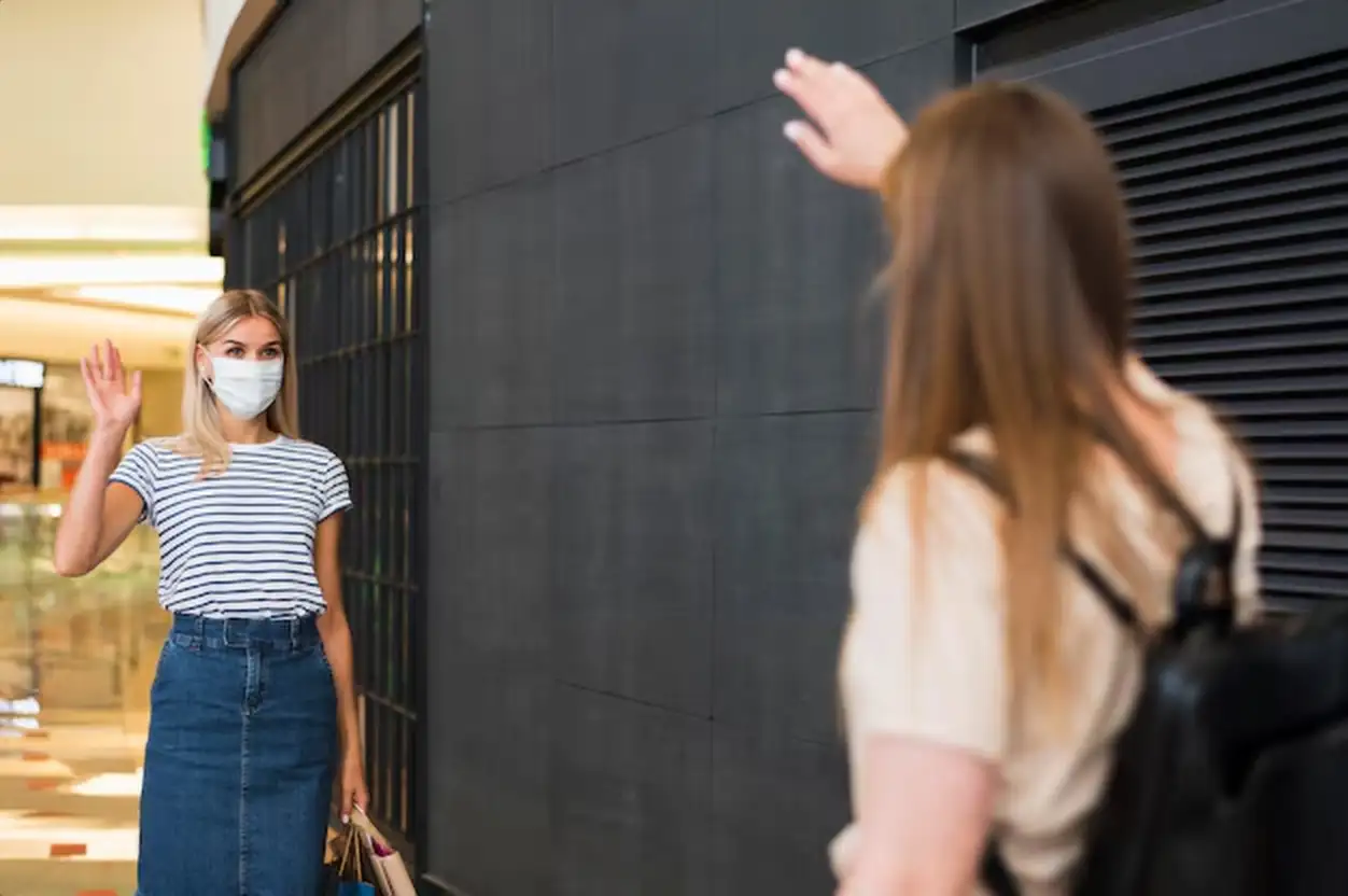 Friends saluting each other at the mall