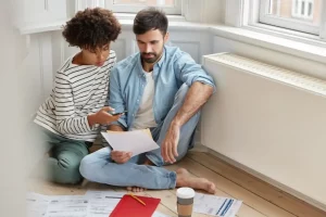 Carefree multiethnic woman and man examine paperwork