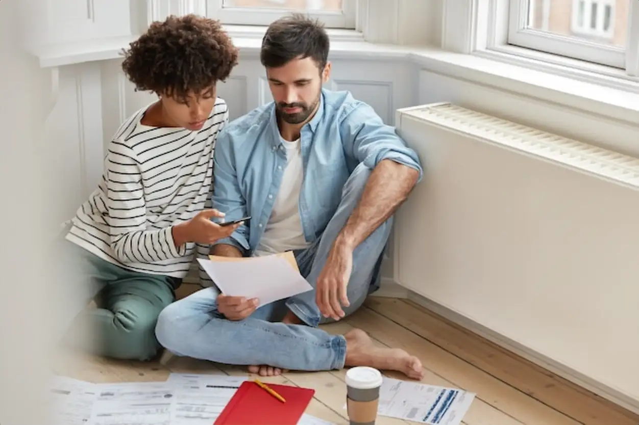 Carefree multiethnic woman and man examine paperwork