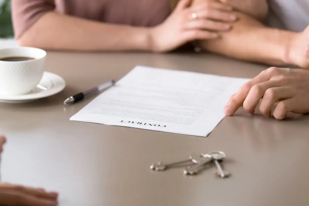 Closeup of contract on the table, couple taking mortgage loan