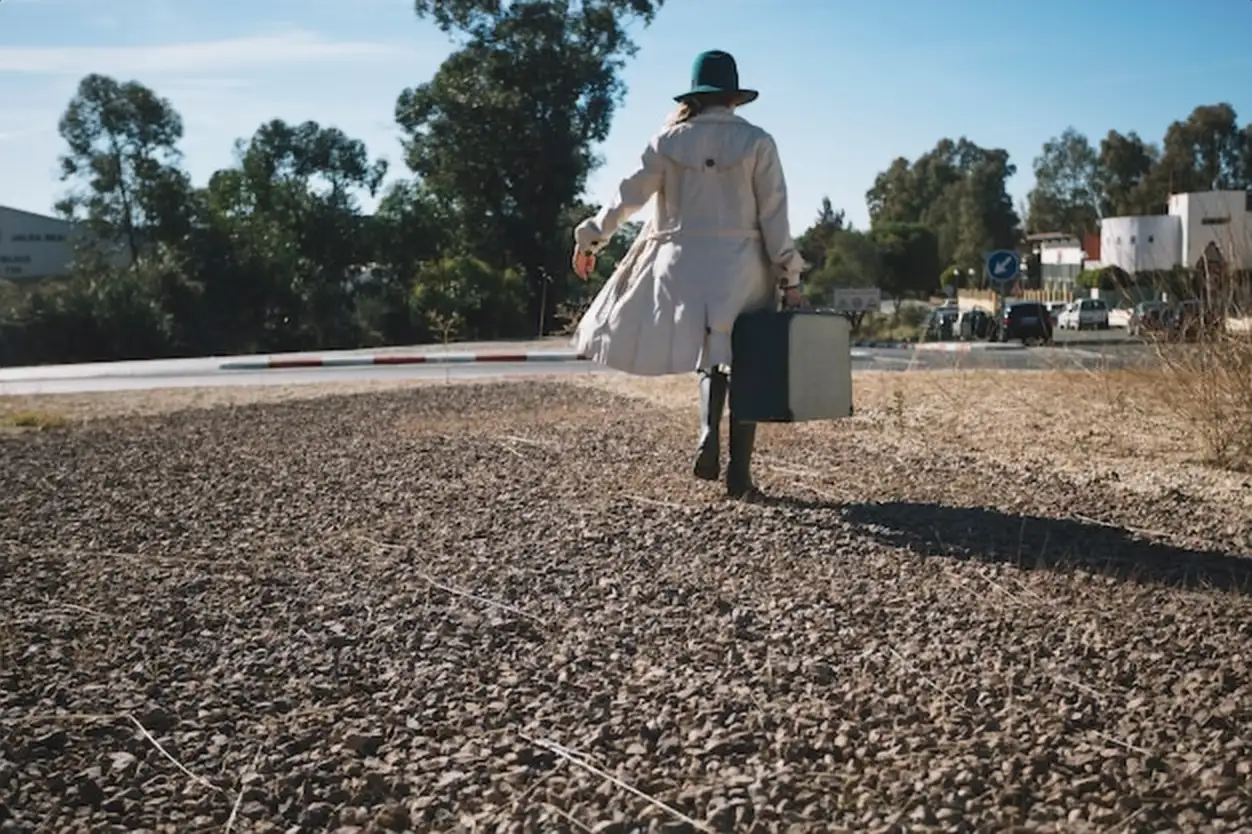 Back view of woman with suitcase